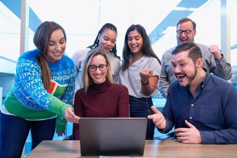 people looking at a laptop